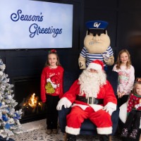 4 little girls smile with Louie and Santa